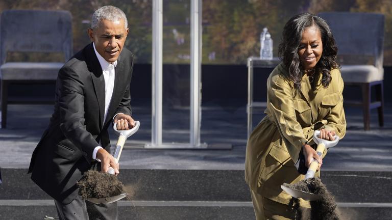 Former President Barack Obama, left, and former first lady Michelle Obama toss shovels of dirt during a groundbreaking ceremony for the Obama Presidential Center Tuesday, Sept. 28, 2021, in Chicago. (AP Photo / Charles Rex Arbogast)