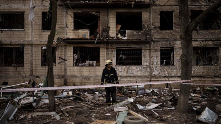 A Ukrainian firefighter walks outside a destroyed building after it was hit by artillery shelling in Kyiv, Ukraine, Monday, March 14, 2022. (AP Photo / Felipe Dana)