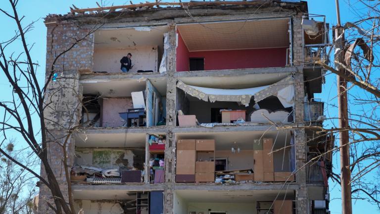 A man walks in his apartment ruined after the Russian shelling in Kyiv, Ukraine, Monday, March 21, 2022. At least eight people were killed in the attack. (AP Photo / Efrem Lukatsky)