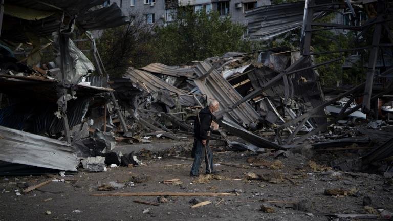 An elderly man walks past a car shop that was destroyed after a Russian attack in Zaporizhzhia, Ukraine, Tuesday, Oct. 11, 2022. (AP Photo / Leo Correa)