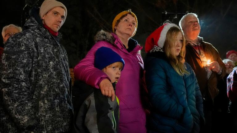 Supporters hold candles during a candlelight vigil Tuesday, Dec. 17, 2024, outside the Wisconsin Capitol in Madison, Wis., following a shooting at the Abundant Life Christian School on Monday, Dec. 16. (AP Photo/Morry Gash)