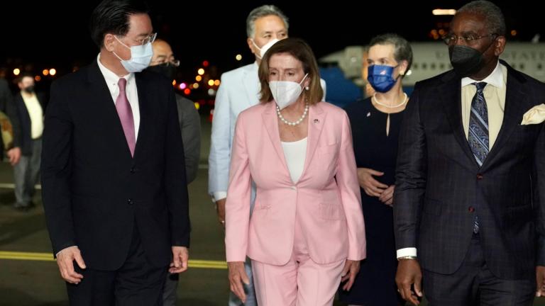 In this photo released by the Taiwan Ministry of Foreign Affairs, U.S. House Speaker Nancy Pelosi, center, walks with Taiwan’s Foreign Minister Joseph Wu, left, as she arrives in Taipei, Taiwan, Tuesday, Aug. 2, 2022. (Taiwan Ministry of Foreign Affairs via AP)