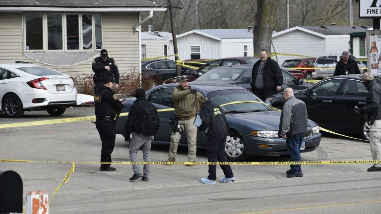 Investigators confer during an investigation outside the Somers House Tavern, in Kenosha, Wis., Sunday morning, April 18, 2021. (Deneen Smith / The Kenosha News via AP)