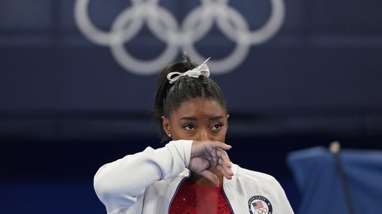 Simone Biles, of the United States, watches gymnasts perform after an apparent injury, at the 2020 Summer Olympics, Tuesday, July 27, 2021, in Tokyo. Biles withdrew from the team finals. (AP Photo / Ashley Landis)