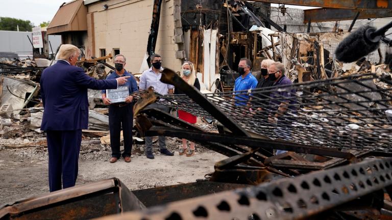 President Donald Trump talks to business owners Tuesday, Sept. 1, 2020, as he tours an area damaged during demonstrations after a police officer shot Jacob Blake in Kenosha, Wis. (AP Photo / Evan Vucci)