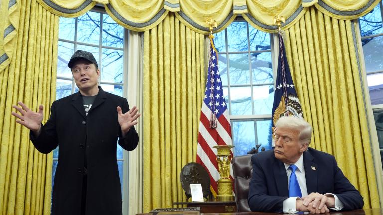 President Donald Trump listens as Elon Musk speaks in the Oval Office at the White House, Tuesday, Feb. 11, 2025, in Washington. (AP Photo/Alex Brandon)