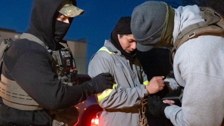 U.S. Immigration and Customs Enforcement officers use a chain to more comfortably restrain a detained person using handcuffs positioned in front, Monday, Jan. 27, 2025, in Silver Spring, Md. (AP Photo / Alex Brandon)