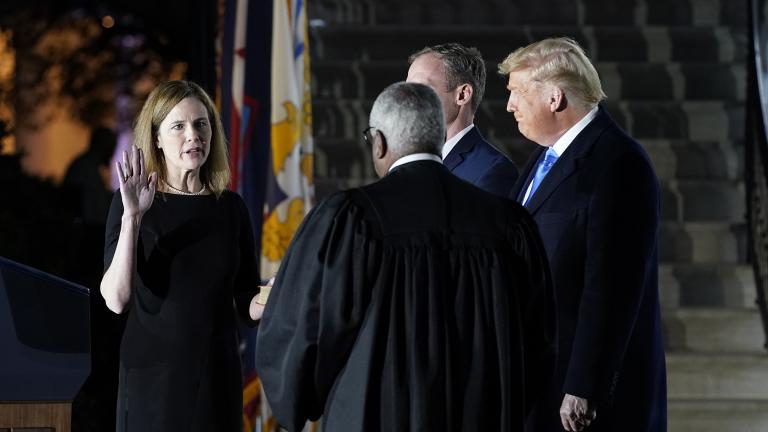 President Donald Trump watches as Supreme Court Justice Clarence Thomas administers the Constitutional Oath to Amy Coney Barrett on the South Lawn of the White House in Washington, Monday, Oct. 26, 2020, after Barrett was confirmed by the Senate earlier in the evening. (AP Photo / Patrick Semansky)