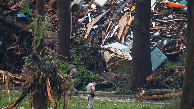 Officials comb through the banks of the Guadalupe River after a flash flood swept through the area Saturday, July 5, 2025, in Hunt, Texas. (AP Photo / Julio Cortez)