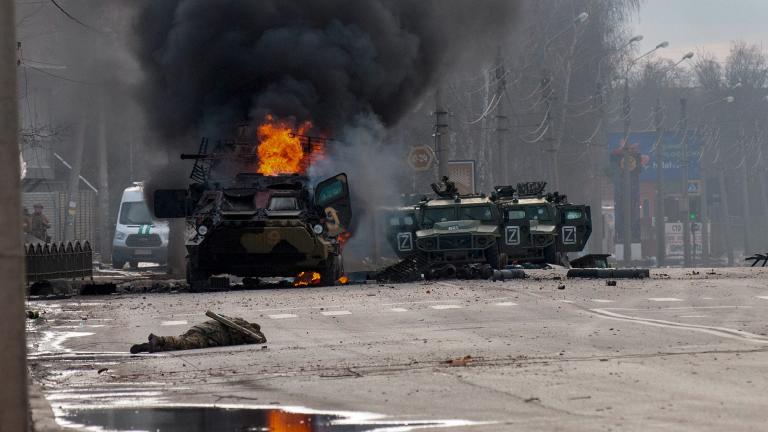 An armored personnel carrier burns and damaged light utility vehicles stand abandoned after fighting in Kharkiv, Ukraine, Sunday, Feb. 27, 2022. (AP Photo / Marienko Andrew)