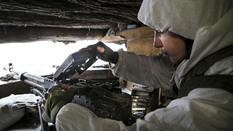 A serviceman checks his machine-gun in a shelter on the territory controlled by pro-Russian militants at frontline with Ukrainian government forces in Slavyanoserbsk, Luhansk region, eastern Ukraine, Tuesday, Jan. 25, 2022. (AP Photo / Alexei Alexandrov)