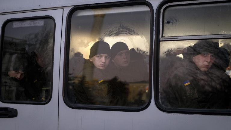 Members of National Guard of Ukraine look out of the window as they ride in a bus through the city of Kyiv, Monday, Feb. 14, 2022. More NATO troops headed to Eastern Europe and some nations worked to move their citizens and diplomats out of Ukraine on Monday. (AP Photo / Emilio Morenatti)