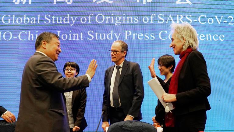 Marion Koopmans, right, and Peter Ben Embarek, center, of the World Health Organization team say farewell to their Chinese counterpart Liang Wannian, left, after a WHO-China Joint Study Press Conference held at the end of the WHO mission in Wuhan, China, Tuesday, Feb. 9, 2021. (AP Photo / Ng Han Guan)