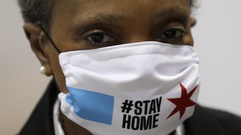 Chicago Mayor Lori Lightfoot wears a mask as she attends a news conference in Hall A of the COVID-19 alternate site at McCormick Place in Chicago, Friday, April 10, 2020. The "alternative care facility" is designed to relieve pressure on city hospitals from rapidly mounting COVID-19 cases. (AP Photo/Nam Y. Huh) Chicago Mayor Lori Lightfoot wears a mask as she attends a news conference in Hall A of the COVID-19 alternate site at McCormick Place in Chicago, Friday, April 10, 2020. The "alternative care facility" is designed to relieve pressure on city hospitals from rapidly mounting COVID-19 cases. (AP Photo/Nam Y. Huh)