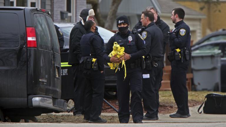 Milwaukee Police Officers and other investigators work near the intersection of North 92nd and West Townsend streets in Milwaukee, Wednesday, March 17, 2021. (Angela Peterson / Milwaukee Journal-Sentinel via AP)