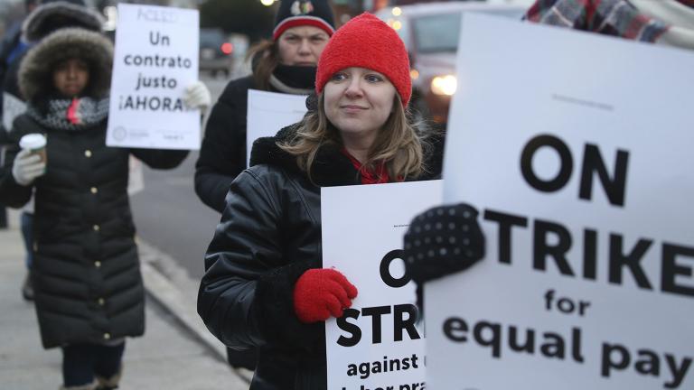 Charter school teachers including Vanessa Cerf-Nikolakakis, center, of Torres Elementary School, and other supporters walk the picket line outside the Acero's Zizumbo Elementary Charter School, Tuesday, Dec. 4, 2018. (Antonio Perez / Chicago Tribune via AP)