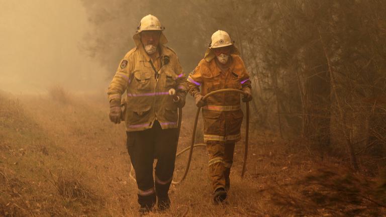 Firefighters drag their water hose after putting out a spot fire near Moruya, Australia, Saturday, Jan. 4, 2020. Australia’s Prime Minister Scott Morrison called up about 3,000 reservists as the threat of wildfires escalated Saturday in at least three states with two more deaths, and strong winds and high temperatures were forecast to bring flames to populated areas including the suburbs of Sydney. (AP Photo / Rick Rycroft)