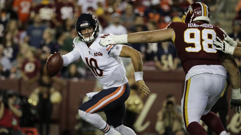 Chicago Bears quarterback Mitchell Trubisky (10) works to escape Washington Redskins defensive end Matthew Ioannidis (98) during the second half of an NFL football game Monday, Sept. 23, 2019, in Landover, Md. (AP Photo / Julio Cortez)