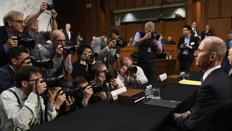 Boeing Company President and CEO Dennis Muilenburg, right, is surrounded by photographers on Capitol Hill in Washington, Tuesday, Oct. 29, 2019, before the start of a Senate Committee on Commerce, Science, and Transportation hearing on “Aviation Safety and the Future of Boeing’s 737 MAX.” (AP Photo / Susan Walsh)