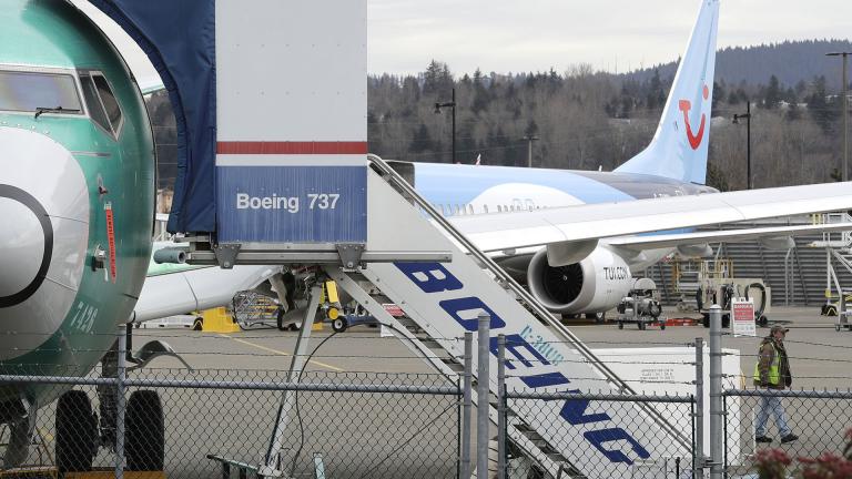 In this photo taken Monday, March 11, 2019, a Boeing 737 MAX 8 airplane being built for TUI Group sits parked in the background at right at Boeing Co.'s Renton Assembly Plant in Renton, Washington.  (AP Photo / Ted S. Warren)