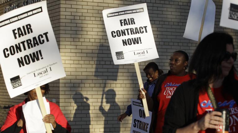 This Sept. 10, 2012 file photo shows Chicago teachers walking a picket line outside a school in Chicago, after they went on strike for the first time in 25 years. (AP Photo / M. Spencer Green, File)