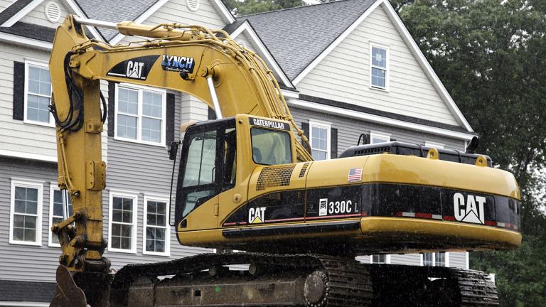 In this July 24, 2017 file photo, a Caterpillar excavator rests at a housing construction site in North Andover, Mass. Caterpillar Inc. reports earnings Tuesday, Oct. 23, 2018. (AP Photo / Elise Amendola, FIle)