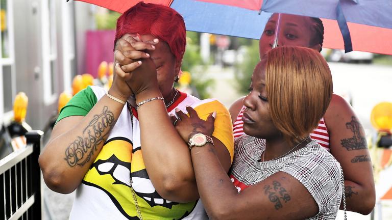  Charvonda Andrews is consoled Tuesday, July 30, 2019 in Chicago as she mourns two women killed July 26 while working as volunteers with a group called Mothers Against Senseless Killings. (John Alexander / Chicago Sun-Times via AP)