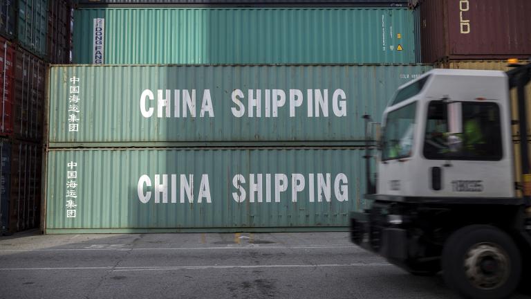 In this July 5, 2018, file photo, a jockey truck passes a stack of 40-foot China Shipping containers at the Port of Savannah in Savannah, Georgia. For months, the U.S. economy has shrugged off the tariffs slapped by America and China on tens of billions of dollars of each other’s goods. (AP Photo / Stephen B. Morton, File)
