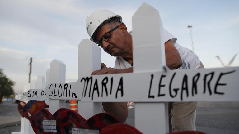 In this Aug. 5, 2019, file photo Greg Zanis prepares crosses to place at a makeshift memorial for victims of a mass shooting at a shopping complex in El Paso, Texas. (AP Photo / John Locher, File)
