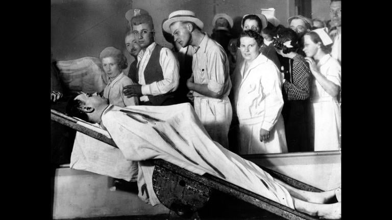In this December 1934 file photo, people view the body of gangster John Dillinger in a Chicago morgue. (AP Photo / File)