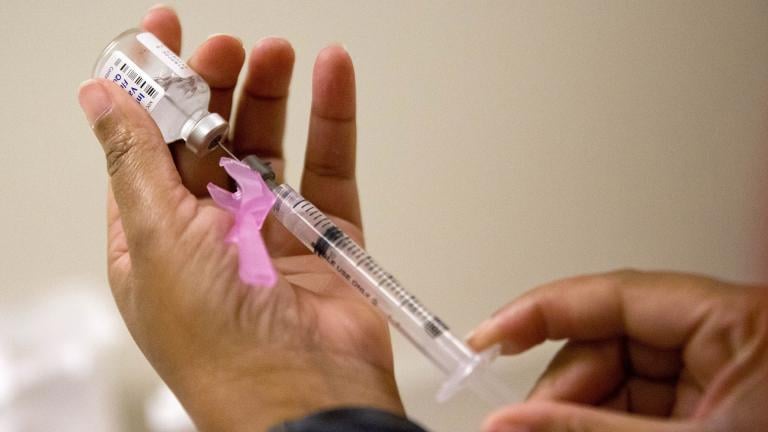 In this Feb. 7, 2018 file photo, a nurse prepares a flu shot at the Salvation Army in Atlanta. (AP Photo / David Goldman)