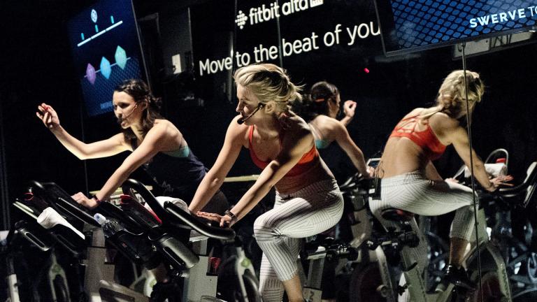 In this March 1, 2017, file photo, Jamey Powell, left, and Julianne Hough lead an exercise class as the participants are introduced to the Alta HR fitness tracker at Swerve cycling center in New York. (AP Photo / Mark Lennihan, File)
