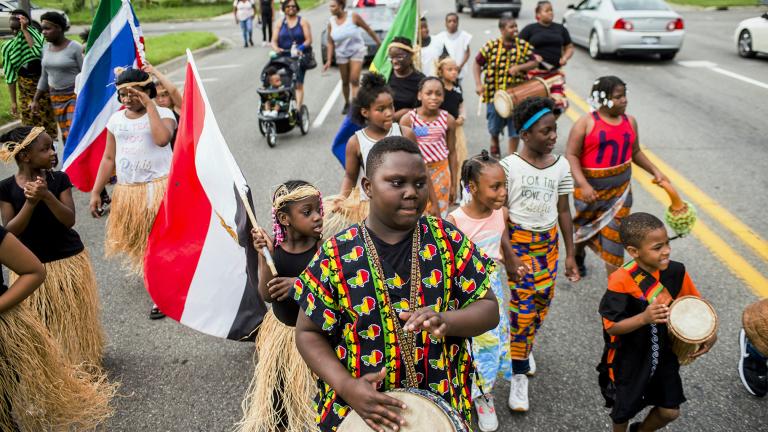 In this June 19, 2018, file photo, Zebiyan Fields, 11, at center, drums alongside more than 20 kids at the front of the Juneteenth parade in Flint, Michigan. (Jake May / The Flint Journal via AP, File)