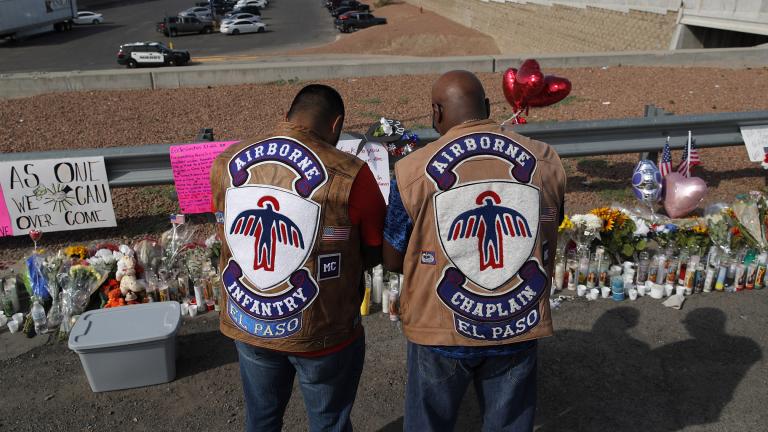 People pray at a makeshift memorial Monday, Aug. 5, 2019 for victims of a mass shooting at a shopping complex in El Paso, Texas. (AP Photo / John Locher)
