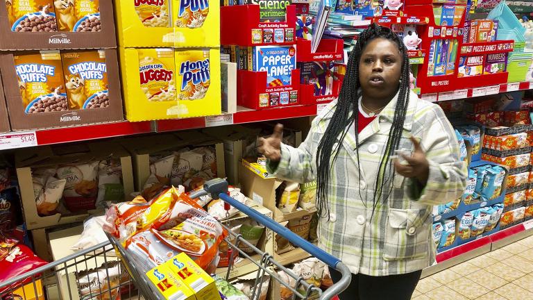 In this Sunday, Feb. 10, 2019 photo, Laquesha Russell, a 36-year-old home health care worker who makes $10.78 an hour, speaks during an interview as she shops for groceries for her four children in Springfield, Illinois. (AP Photo / John O’Connor)