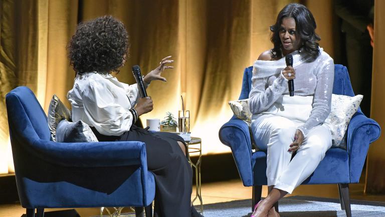 Michelle Obama, right, discusses her new book with Oprah Winfrey during an intimate conversation to promote “Becoming” at the United Center on Tuesday, Nov. 13, 2018. (Photo by Rob Grabowski / Invision / AP)