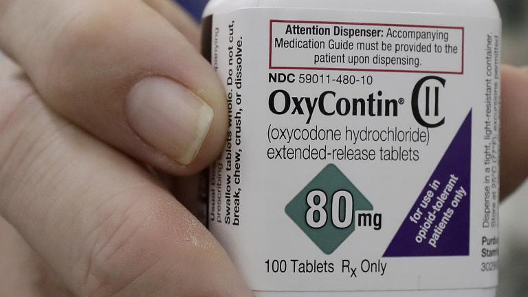 In this April 2, 2018, file photo, a pharmacist in San Francisco poses for photos holding a bottle of OxyContin. (AP Photo / Jeff Chiu, File) In this April 2, 2018, file photo, a pharmacist in San Francisco poses for photos holding a bottle of OxyContin. (AP Photo / Jeff Chiu, File)