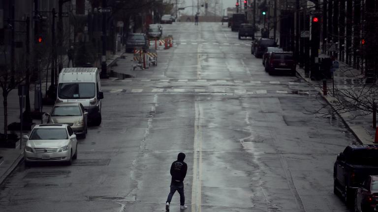 In this April 3, 2020, file photo a man crosses an empty street in downtown Kansas City, Missouri. (AP Photo / Charlie Riedel, File)