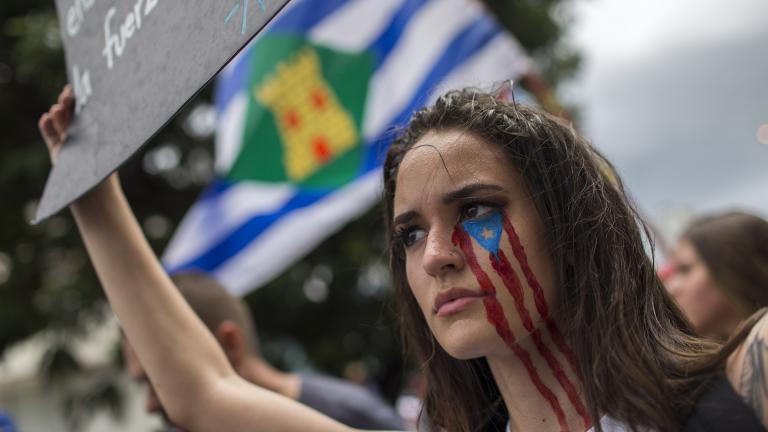 In this July 25, 2019 photo, a young woman takes part in the festivities to celebrate the resignation of Gov. Ricardo Rossello, after weeks of protests over leaked obscene, misogynistic online chats, in San Juan, Puerto Rico. (AP Photo / Dennis M. Rivera Pichardo)