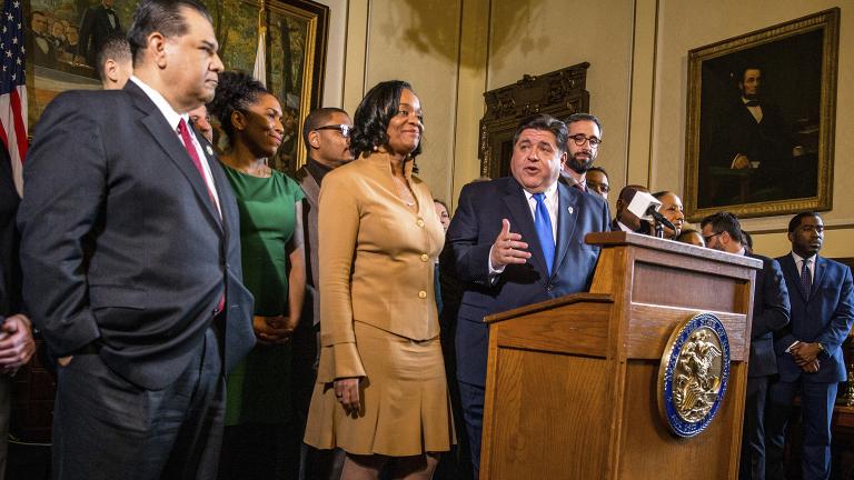 Gov. J.B. Pritzker gives his opening remarks along with state Sen. Kimberly Lightford, D-Maywood, left, on Senate Bill 1, a bill sponsored by Lightford to raise the state’s minimum wage to $15 an hour by 2025, after it passed the Illinois Senate during a press conference in the governor’s office at the Illinois state Capitol, Thursday, Feb. 7, 2019. (Justin L. Fowler / The State Journal-Register via AP)