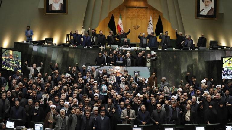 Iranian lawmakers chant slogans as some of them hold posters of Gen. Qassem Soleimani, who was killed in Iraq in a U.S. drone attack, in an open session of parliament, in Tehran, Iran, Tuesday, Jan. 7, 2020. (AP Photo / Vahid Salemi)