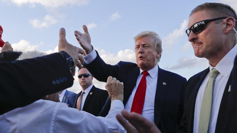 President Donald Trump reaches out to greet supporters on the tarmac upon his arrival at Palm Beach International Airport on Thursday, April 18, 2019, in West Palm Beach, Florida. (AP Photo / Pablo Martinez Monsivais)