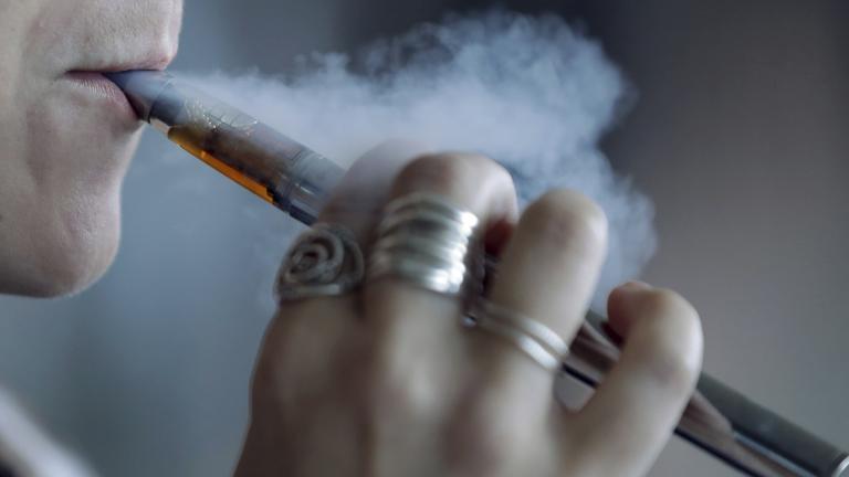In this Friday, Oct. 4, 2019 file photo, a woman using a vaping device exhales a puff of smoke in Mayfield Heights, Ohio. (AP Photo / Tony Dejak, File)