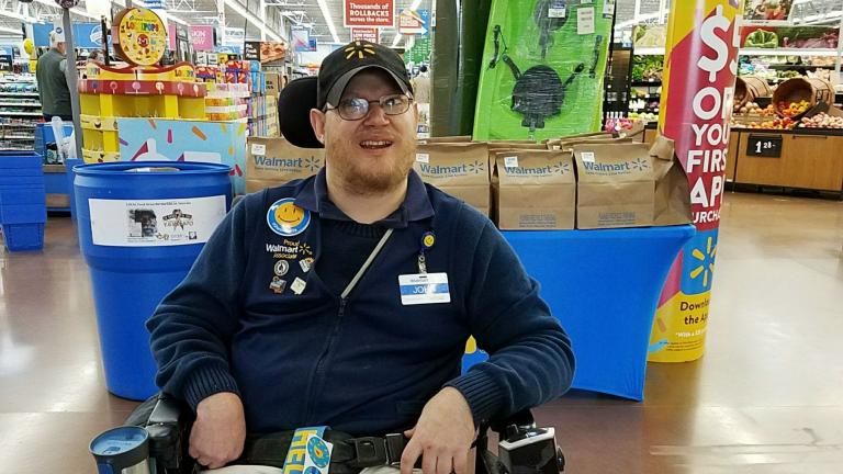 In this April 21, 2018 photo provided by Rachel Wasser, Walmart greeter John Combs works at a Walmart store in Vancouver, Washington. (Rachel Wasser via AP)