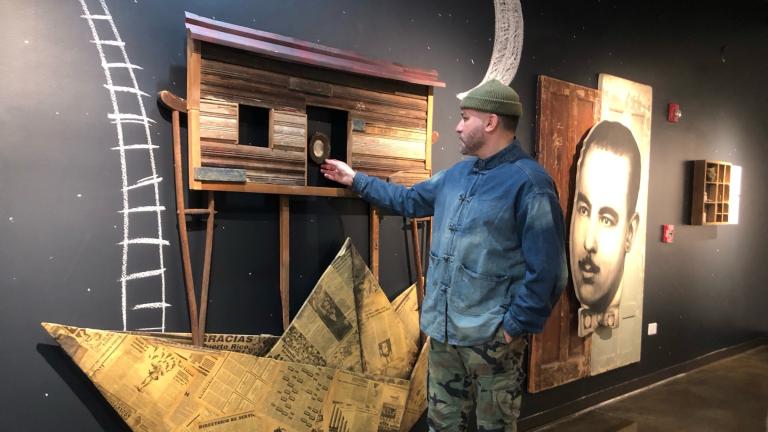 Adrián Viajero Román at “Archivos Vivos,” his new exhibition at the National Museum of Puerto Rican Arts and Culture.  (Marc Vitali / WTTW News)
