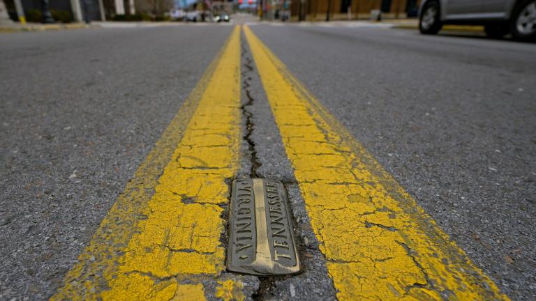 Brass markers, marking the state line between Bristol, Tenn. and Bristol, Va., line State Street in Bristol, Va., on Thursday, Feb. 23, 2023. (AP Photo / Earl Neikirk)