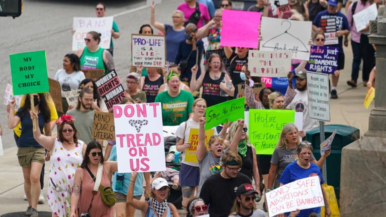 Abortion-rights protestors march between the Indiana Statehouse and the Indiana State Library where Vice President Kamala Harris was meeting with Indiana legislators to discuss reproductive right in Indianapolis, Monday, July 25, 2022. (AP Photo / Michael Conroy)