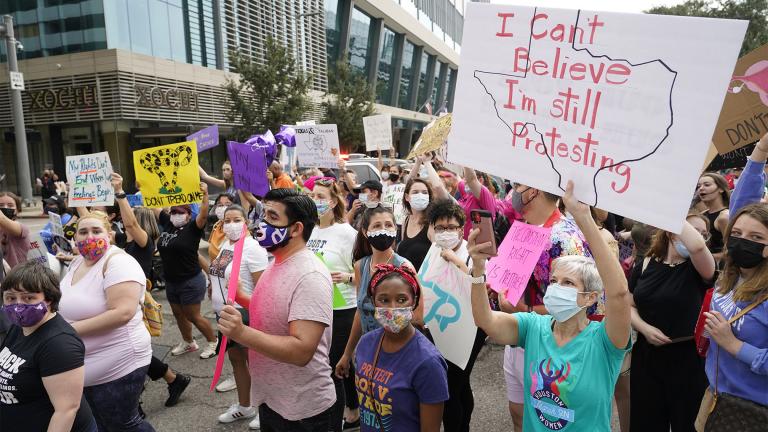 In this Oct. 2, 2021 file photo people participate in the Houston Women's March against Texas abortion ban walk from Discovery Green to City Hall in Houston. (Melissa Phillip / Houston Chronicle via AP, File)