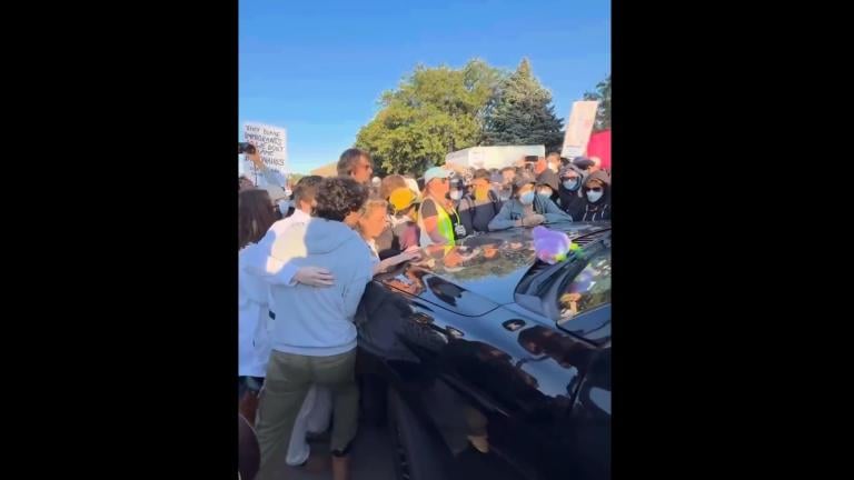 Congressional candidate Kat Abughazaleh, left, is seen along with a crowd around a vehicle on Sept. 26, 2025, outside the Broadview ICE facility. (Credit: Kat Abughazaleh)