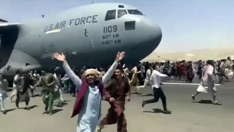 Hundreds of people run alongside a U.S. Air Force C-17 transport plane as it moves down a runway of the international airport, in Kabul, Afghanistan, Monday, Aug.16. 2021. (Verified UGC via AP)
